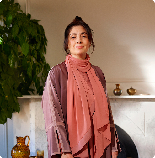 Portrait of a smilling Middle Eastern postmenopausal woman representing the MONALEESA-3 advanced breast cancer clinical trial.